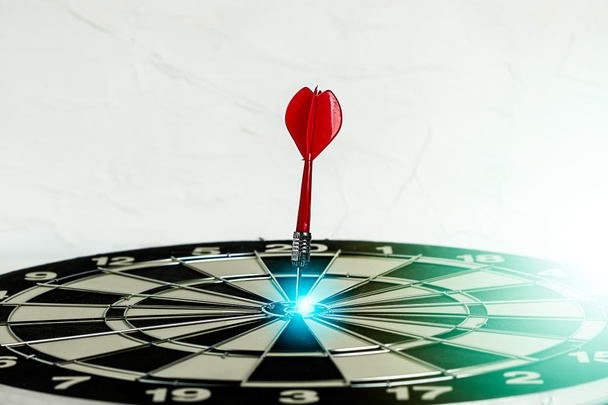 Background with symbol concept of business success achievement focus with red dart game aim and hit center target spot on dartboard for a professional winning - Photo, Image