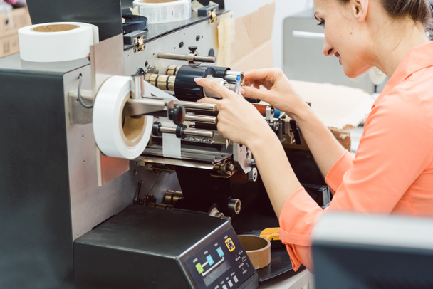 Woman working on label printing machine - Photo, Image