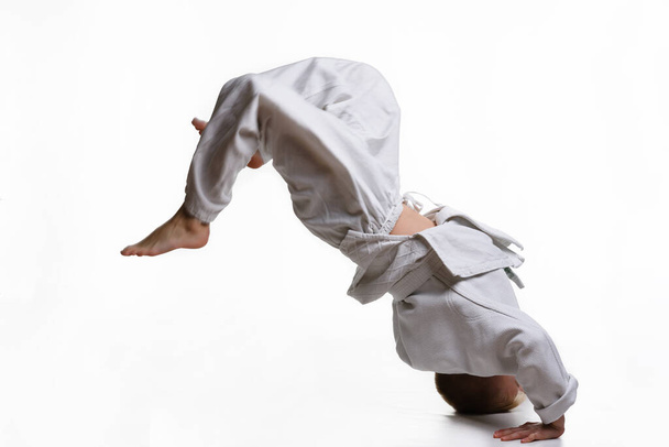 Judo boy in white kimono doing somersault - Φωτογραφία, εικόνα