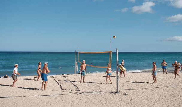 people playing volleyball on the beach on a sunny day - Photo, image