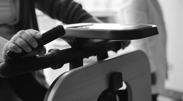 Exercise bike in medical practice. Close-up user hands.  - Фото, зображення