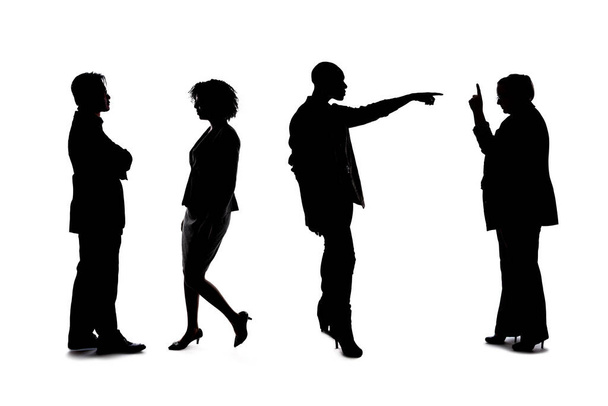 Silhouettes of a group of workers depicting a company or networking event.  The businessmen and businesswomen are unrecognizable and anonymous and represents an office team or staff. - Photo, Image