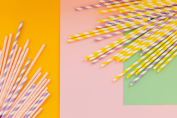 Drinking paper straws on bright background,copy space. Top view of colored paper disposable eco-friendly straws for summer cocktails.biodegradable eco-friendly paper straws. cocktail tubes. - Photo, Image