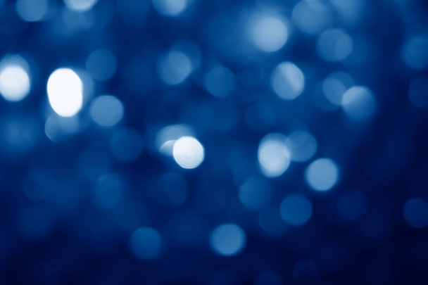 abstract blurred circular bokeh lights background toned in trendy Classic Blue color of the Year 2020 - Fotografie, Obrázek