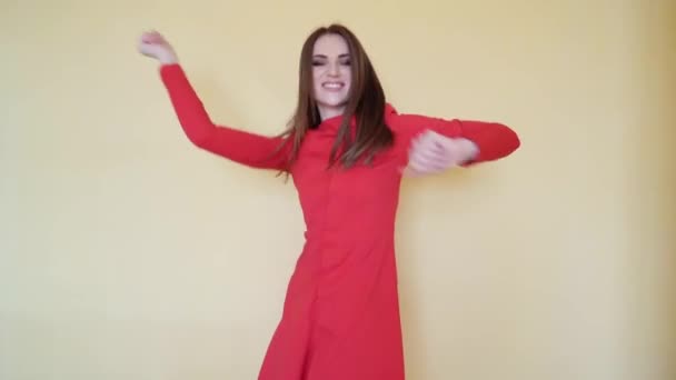 girl in red dress with long dark hair has fun - Video