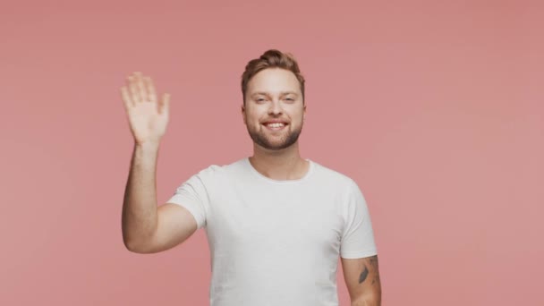Expressive and happy young man over vibrant background. Studio portrait of smiling handsome person. - Materiał filmowy, wideo