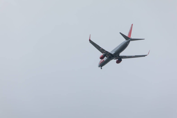 Pula, Croatia - May 19, 2019: big plane aircraft in overcast sky landing - Zdjęcie, obraz