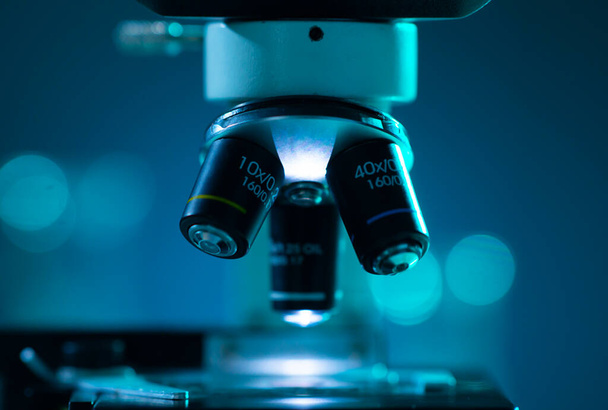 Close-up of scientific microscope. Laboratory in hospital. Epidemic disease, healthcare, vaccine research and coronavirus covid-19 test concept. - Фото, изображение