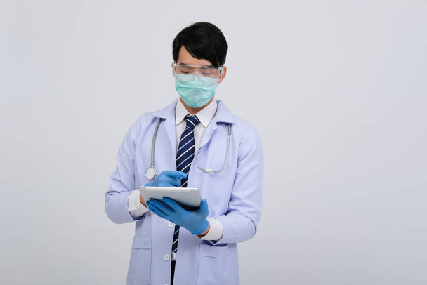 doctor physician practitioner wearing mask with tablet & stethoscope on white background. medical professional medicine healthcare concept - Fotografie, Obrázek