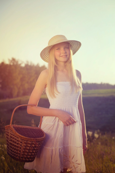 Girl with crib in summer field - Foto, imagen