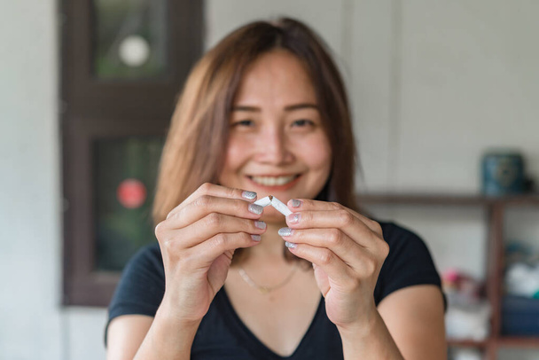 Asian woman hand crushing cigarette, No smoking concept - Фото, зображення