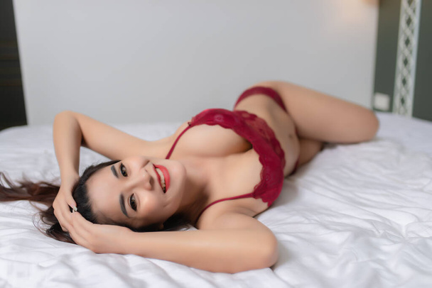 Portrait of beautiful asian sexy woman in the bedroom - Zdjęcie, obraz