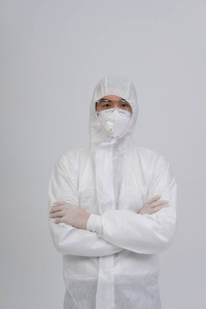 man doctor wearing biological protective uniform suit clothing, mask, gloves for preventing virus bacteria infection contamination - Valokuva, kuva