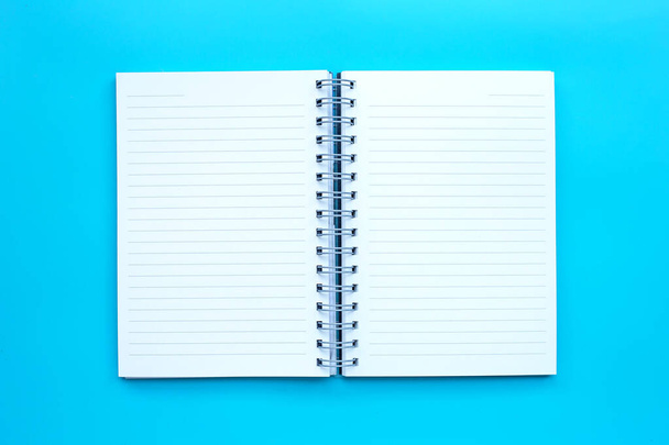 Open diary on blue background. Top vie - Photo, Image
