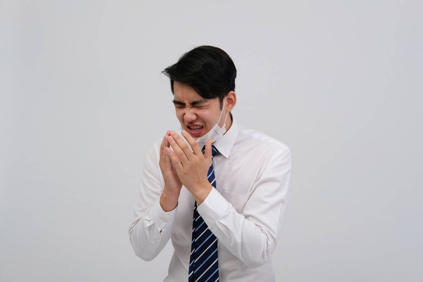 ill businessman man feeling sick, sneezing coughing wearing protective mask against cold flu virus bacteria infection pollution - 写真・画像