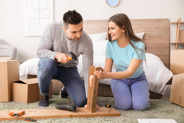 Young couple assembling furniture at home - Photo, Image
