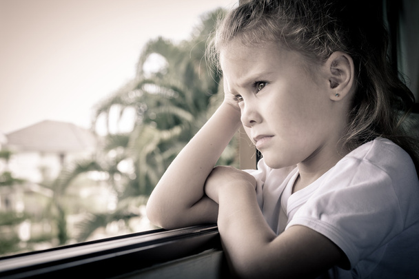 portrait of a sad girl sitting near the window - Foto, Imagen