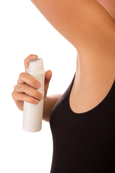 Unidentified woman applying deodorant on armpit isolated on white background. - Foto, afbeelding