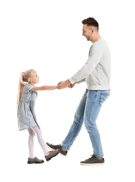 Man and his little daughter dancing against white background - Fotografie, Obrázek