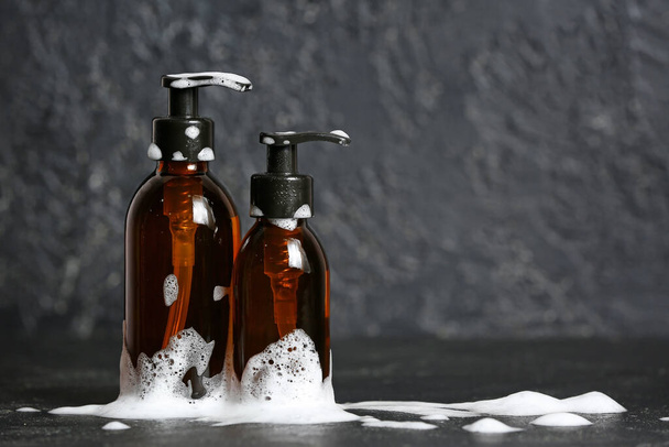 Shampoo and foam on dark background - Photo, Image