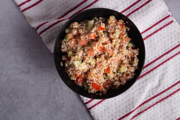 Traditional Arabic Salad Tabbouleh with couscous, vegetables and greens - Photo, Image