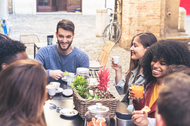 Multiracial friends, girls and guys, having fun laughing drinking coffee tea in coffeehouse, happy diverse young people talking joking sitting together at cafe table, multicultural friendship concept - Photo, image