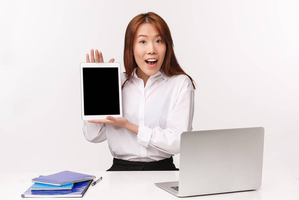 Career, work and women entrepreneurs concept. Close-up portrait of professional young enthusiastic office lady, manager introducing her project on tablet, showing display, white background - Photo, Image