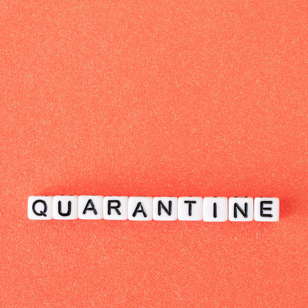 The word quarantine on red background. Worldwide pandemic concept, production and work shutdown - Valokuva, kuva
