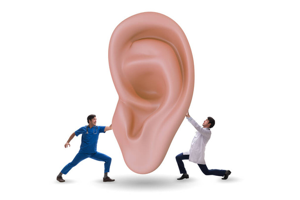 医者は医療の概念で巨大な耳を調べる - 写真・画像