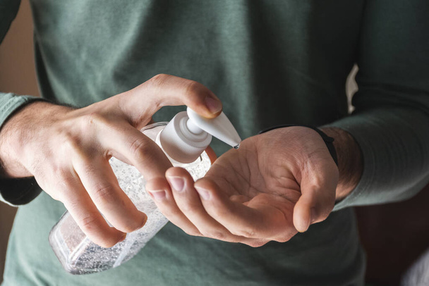 Man spreading disinfectant gel on his hands - Фото, зображення