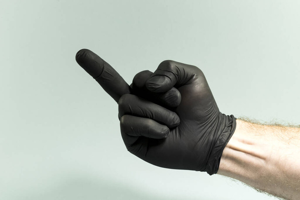 Hand gestures on a gray background in a sterile rubber glove shot with a large lan. - Fotó, kép