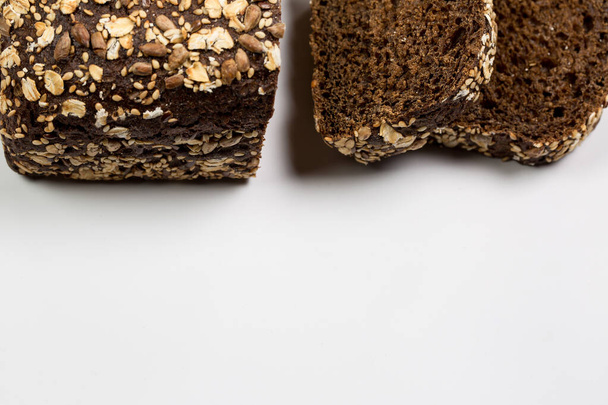 Tasty fresh black and white bread with wheat and flour on a white background - Valokuva, kuva