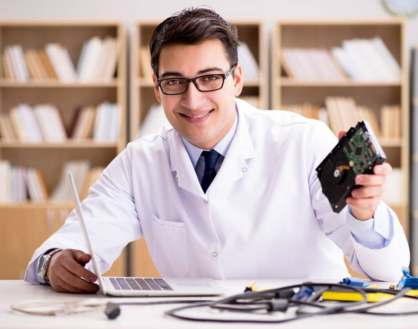 Proffesional repairman repairing broken hard drive - Фото, изображение