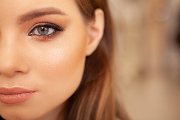 Cropped close up of a young beautiful woman with professional nude makeup. Skin, cosmetics concept - Photo, image