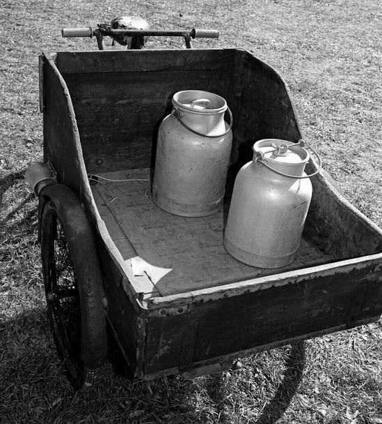 vélo avec bidon de lait utilisé il y a longtemps par le laitier pour livrer le lait frais à effet noir et blanc
 - Photo, image