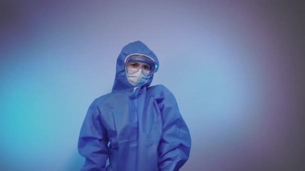 Virus. The doctor punches the air in a protective suit against the virus. - Materiaali, video