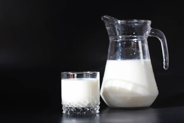 Milk drink in glass. Farm milk and cookies. Delicious snack with cow's milk and fresh pastries. - Photo, Image