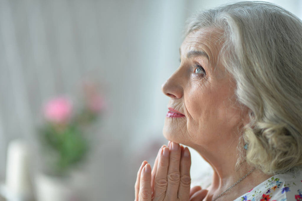 Portrait of beautiful  senior woman praying - Фото, изображение