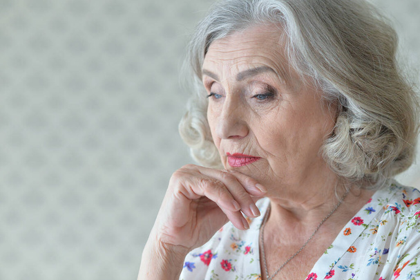 Close up portrait of sad senior woman at home  - Фото, зображення