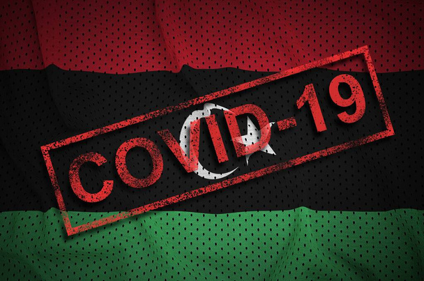 Libië vlag en rode Covid-19 stempel. Coronavirus 2019-ncov-uitbraak concept - Foto, afbeelding