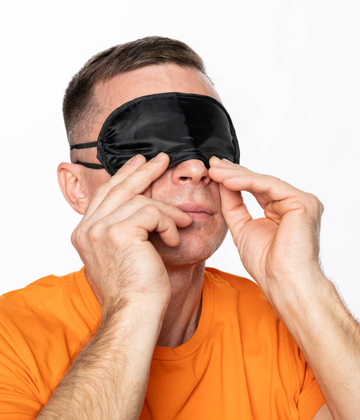 Young man in black  sleeping mask  posing over white background - Photo, Image