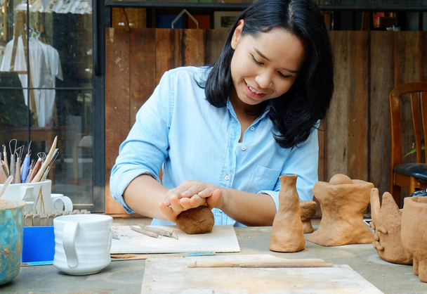 Asian woman molding handmade cray in studio, hobby and lifestyle work concept - Photo, Image