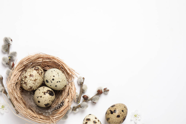 Flat lay composition with quail eggs on white background, space for text. Easter celebration - Fotografie, Obrázek