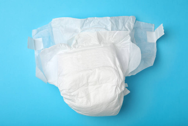 Baby diaper on light blue background, top view - Foto, Imagem