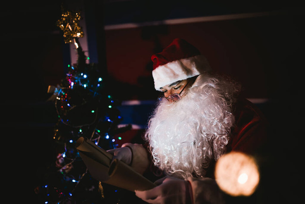 Portrait of santa clause read paper and checking list name for send gift to children - Φωτογραφία, εικόνα