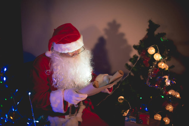 Portrait of santa clause read paper and checking list name for send gift to children - Foto, Bild