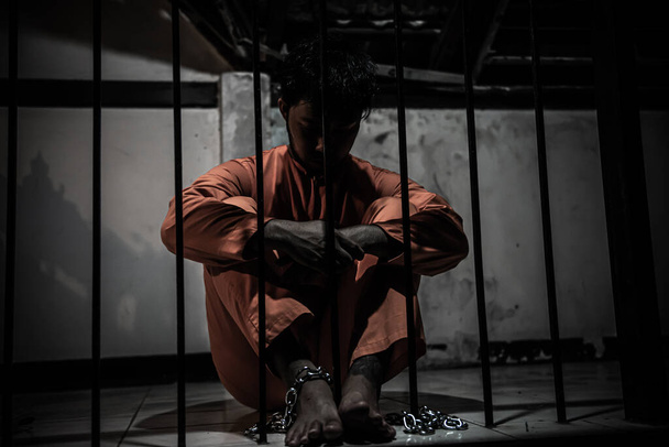 Asian man desperate at the iron prison, prisoner concept - Foto, Bild