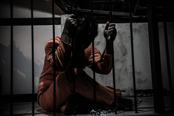 Asian man desperate at the iron prison, prisoner concept - Fotó, kép