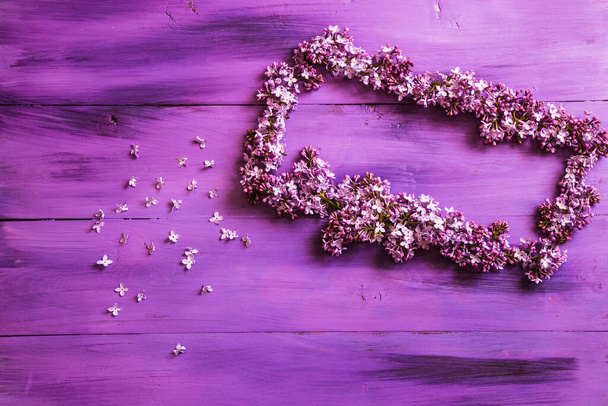 spring lilac on a wooden, purple background. - Fotó, kép