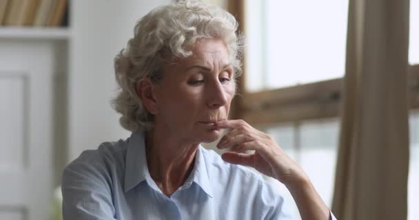 Thoughtful middle aged hoary woman feeling lonely at home. - Filmmaterial, Video